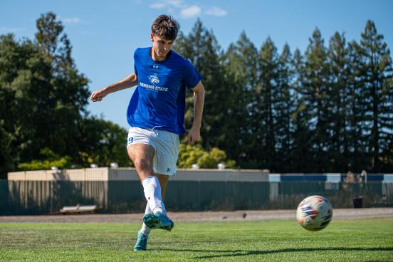 Player kicks the soccer ball