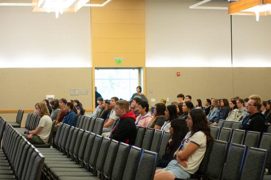 An audience watches intently
