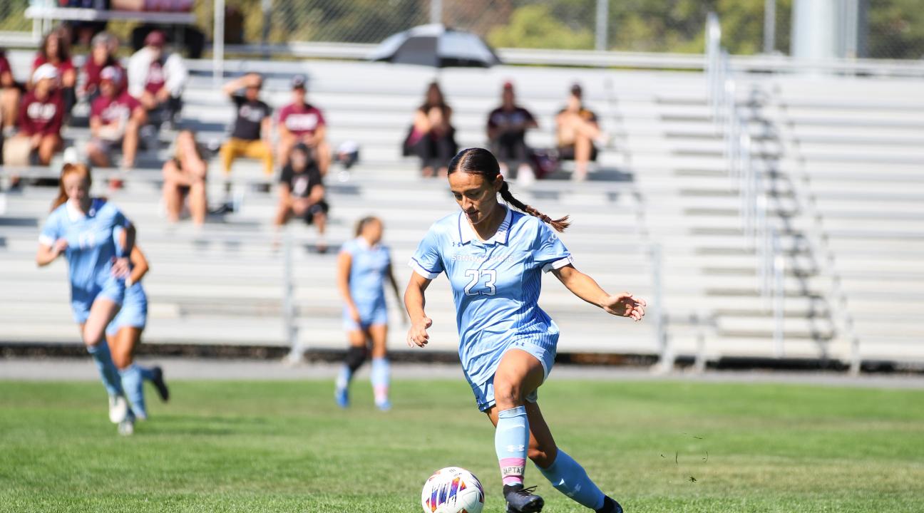 Student kicking a soccer ball