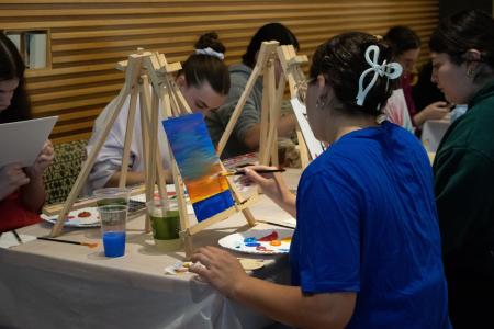 Student painting at paint and sip event